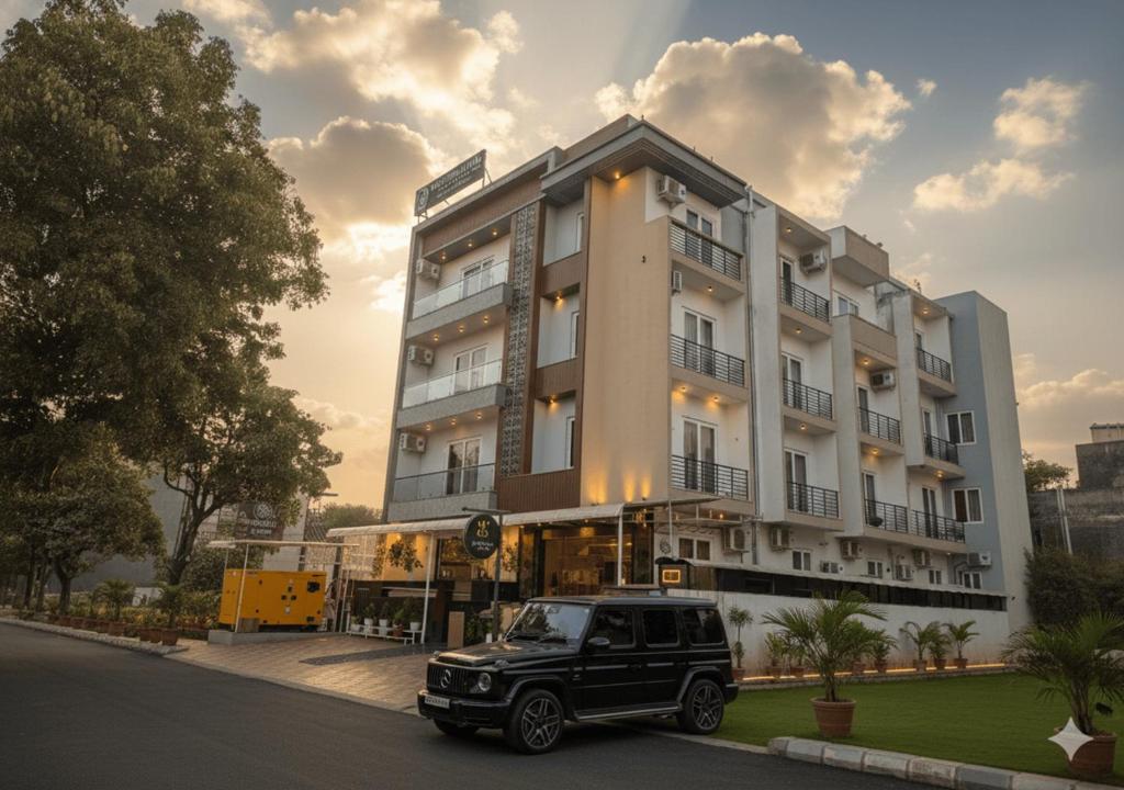 a black suv parked in front of a building at Honeyveils Palace Hotel - Behind Indian Expo Mart in Greater Noida