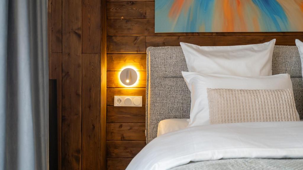 a bedroom with a bed with a light next to it at Winterfell in New Gudauri in Gudauri