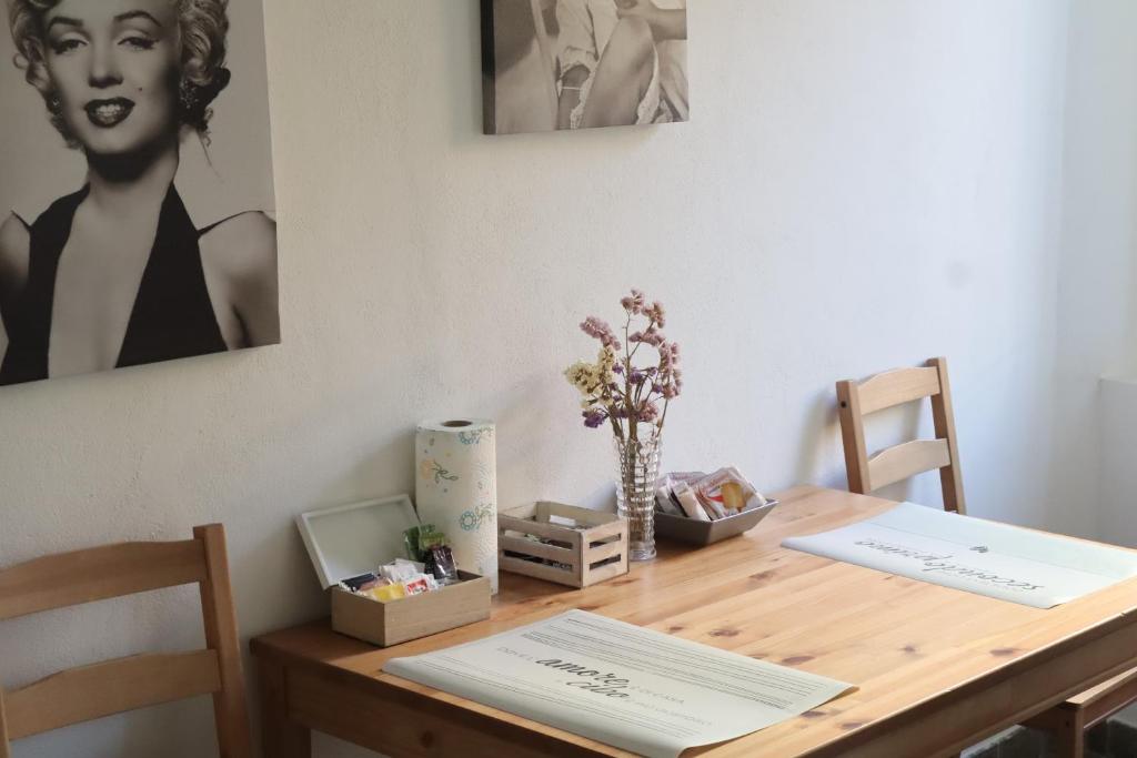 un tavolo in legno con due sedie e un tavolo con fiori di porta merlonia house minimono a Forlì