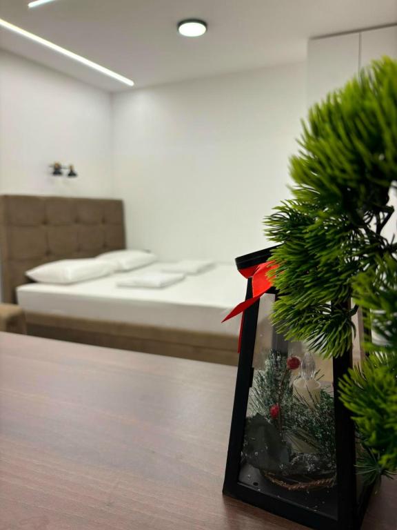 a room with a bed and a christmas tree at Apartman Andrijana in Bajina Bašta