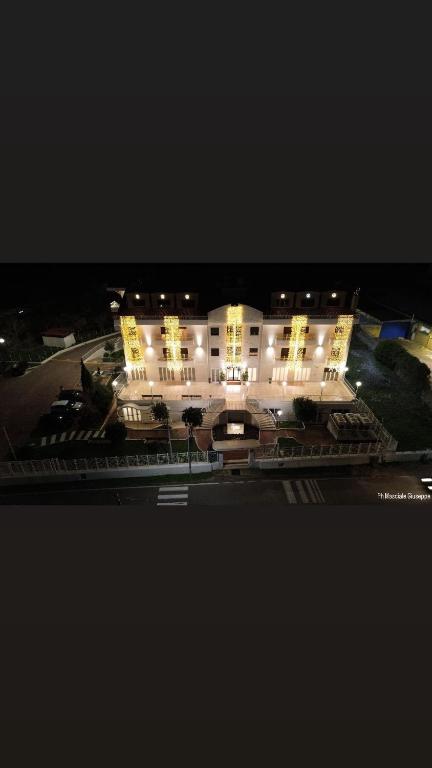 a large building is lit up at night at Easy Green Hotel in San Giovanni Rotondo