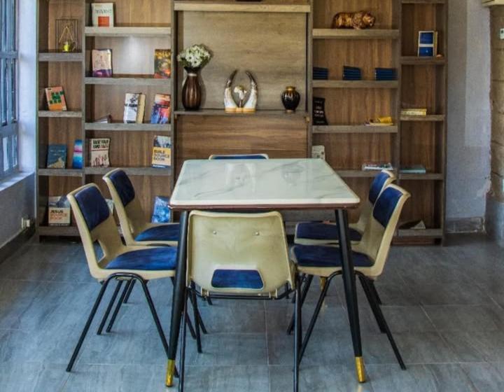 a table and four chairs in a room at Bethel house ruiru in Ruiru
