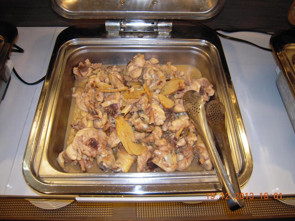 a pan of chicken and vegetables on a table at Chiayi Look Hotel in Chiayi City