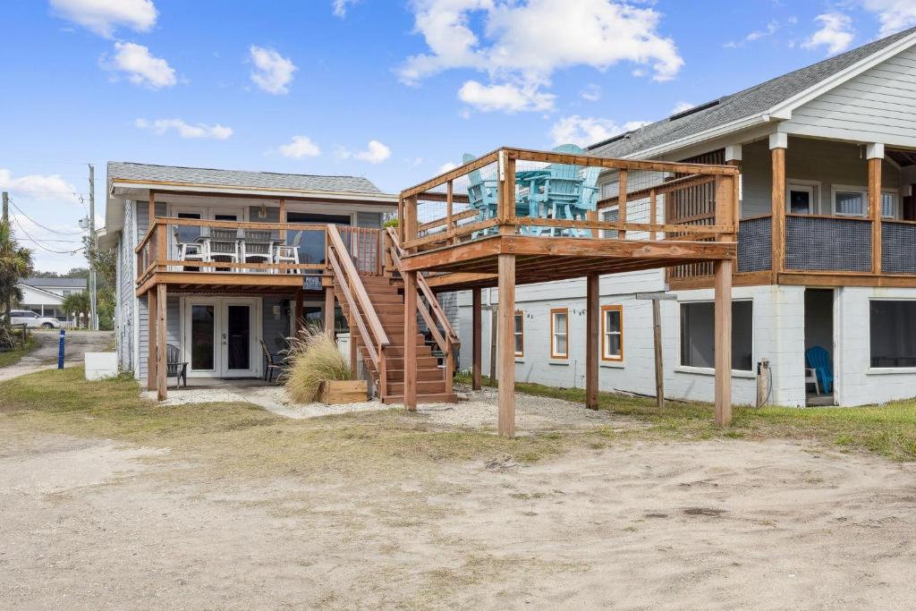 a house with a deck on the side of it at Spacious Beachfront Duplex - Top Floor - Dog Friendly - 124 S Fletcher in Fernandina Beach