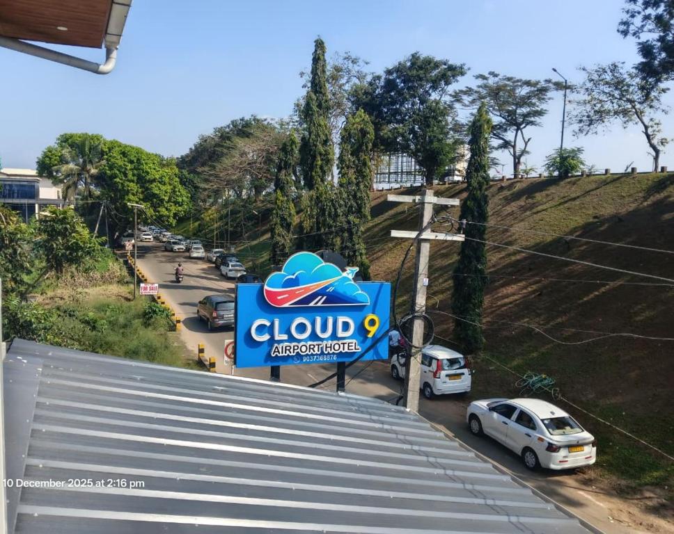 a close up of a clud appliance sign next to cars at Cloud9 Airport Hotel in Nedumbassery