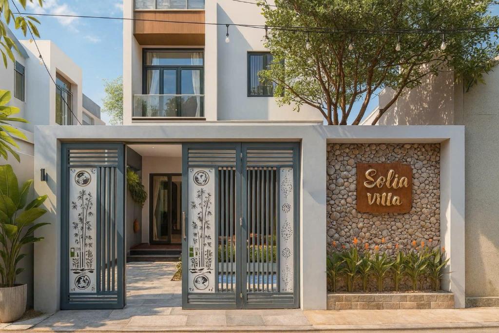 a villa with a gate in front of a building at Solia Villa in Da Nang