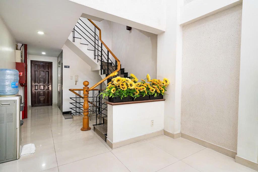 a hallway with a staircase with a potted plant at Đình Đinh Hotel in Ho Chi Minh City