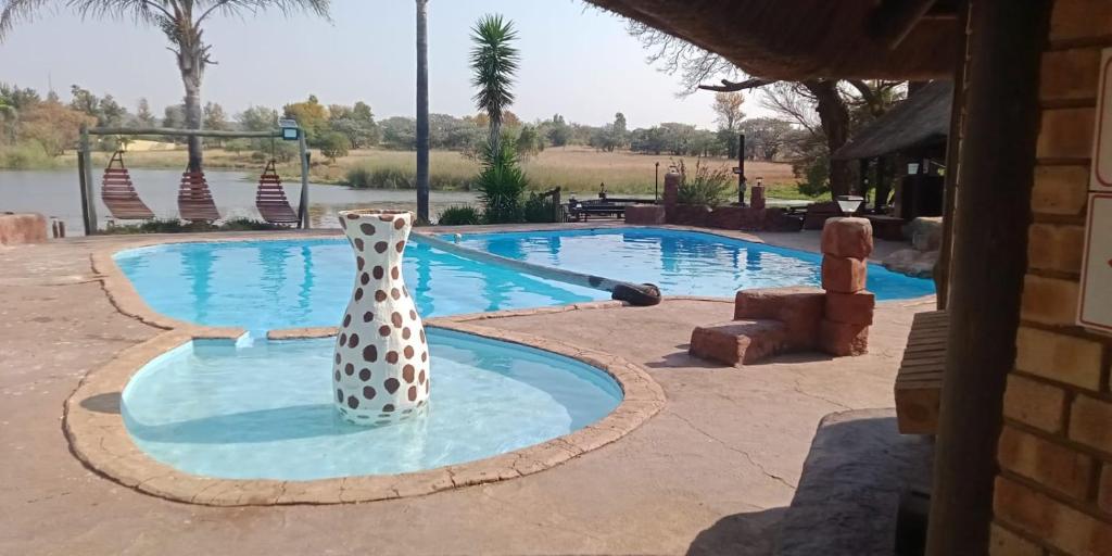 a vase sitting in the middle of a swimming pool at Lush Horizons Game Lodge in Modimolle