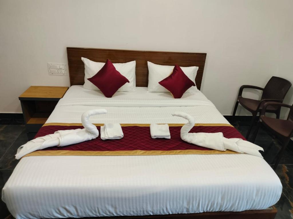 a bedroom with a bed with two swans on it at VGN Convention Centre in Vāniyambādi
