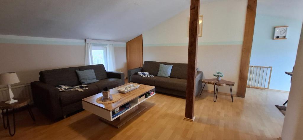 a living room with a couch and a coffee table at Kleine Strandperle in Fehmarn