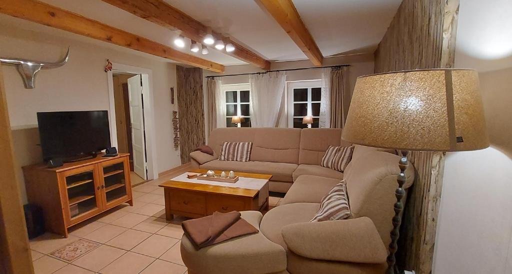 a living room with a couch and a television at Große Strandperle in Fehmarn