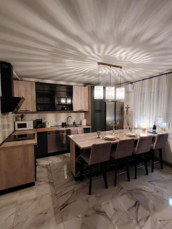 a large kitchen with a table and chairs in it at Apartman Novska Noemi in Novska