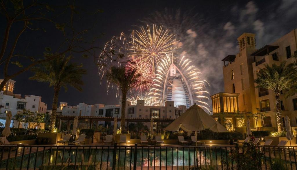 a firework display with a ferris wheel in the background at Ultimate Stay / Burj Al Arab View / Brand New / Amazing Pool with a View / Perfect Holiday / Madinat Jumeirah / 2 BDR in Dubai