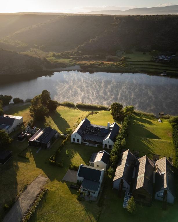 an aerial view of a house next to a lake at Kalm - Riverside living in Malgas