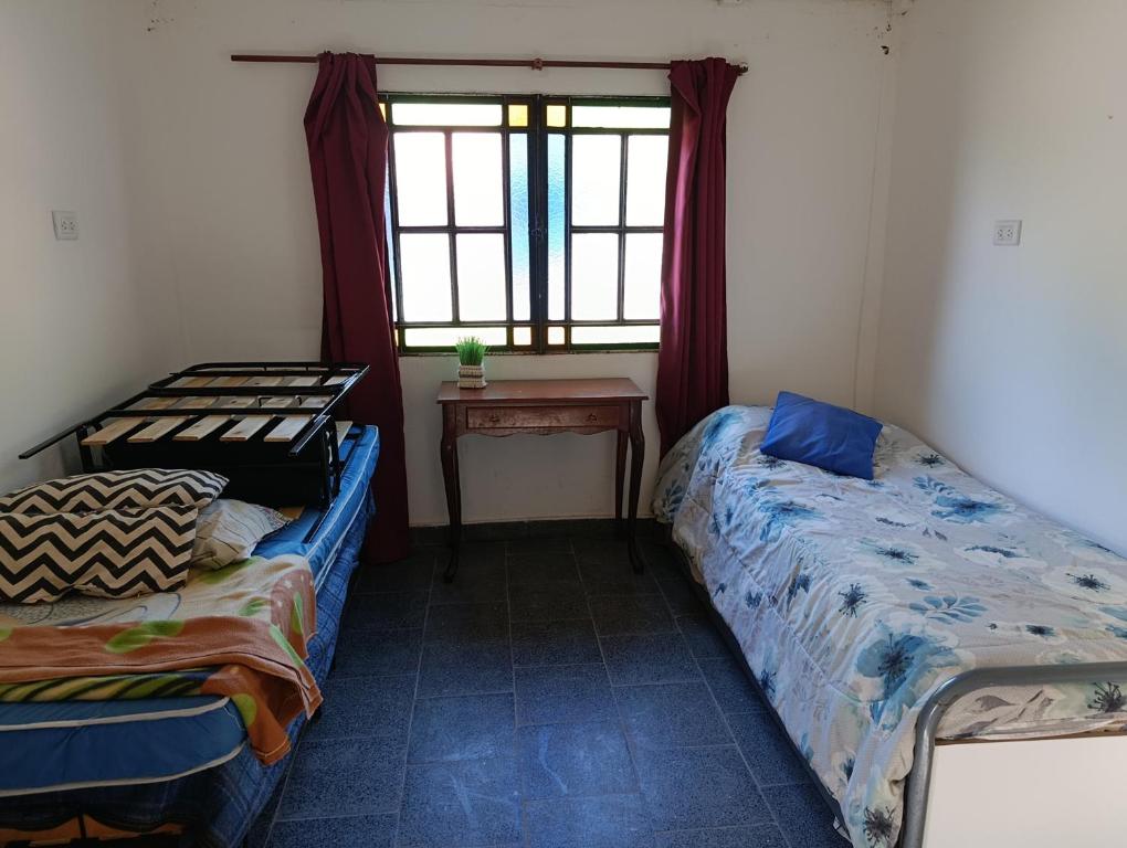 Ένα ή περισσότερα κρεβάτια σε δωμάτιο στο Areco hospedaje 2