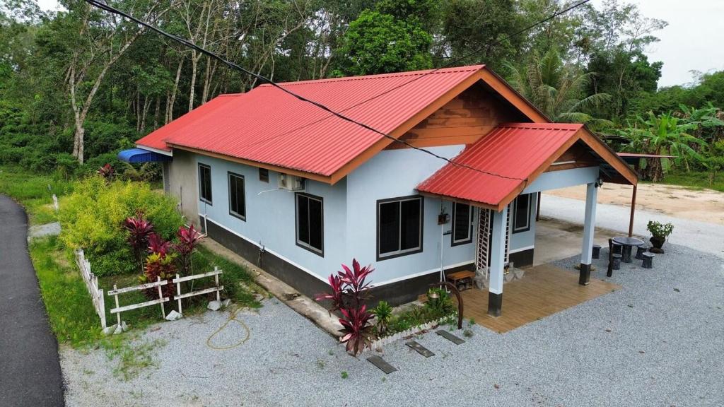 a small house with a red roof at The Nook Housestay in Ketereh