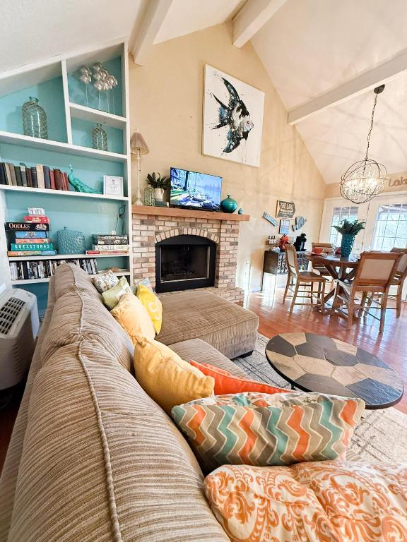 a living room with a couch and a fireplace at Fins Up Margaritaville 2BD3BALoftGrillFirepit in Osage Beach