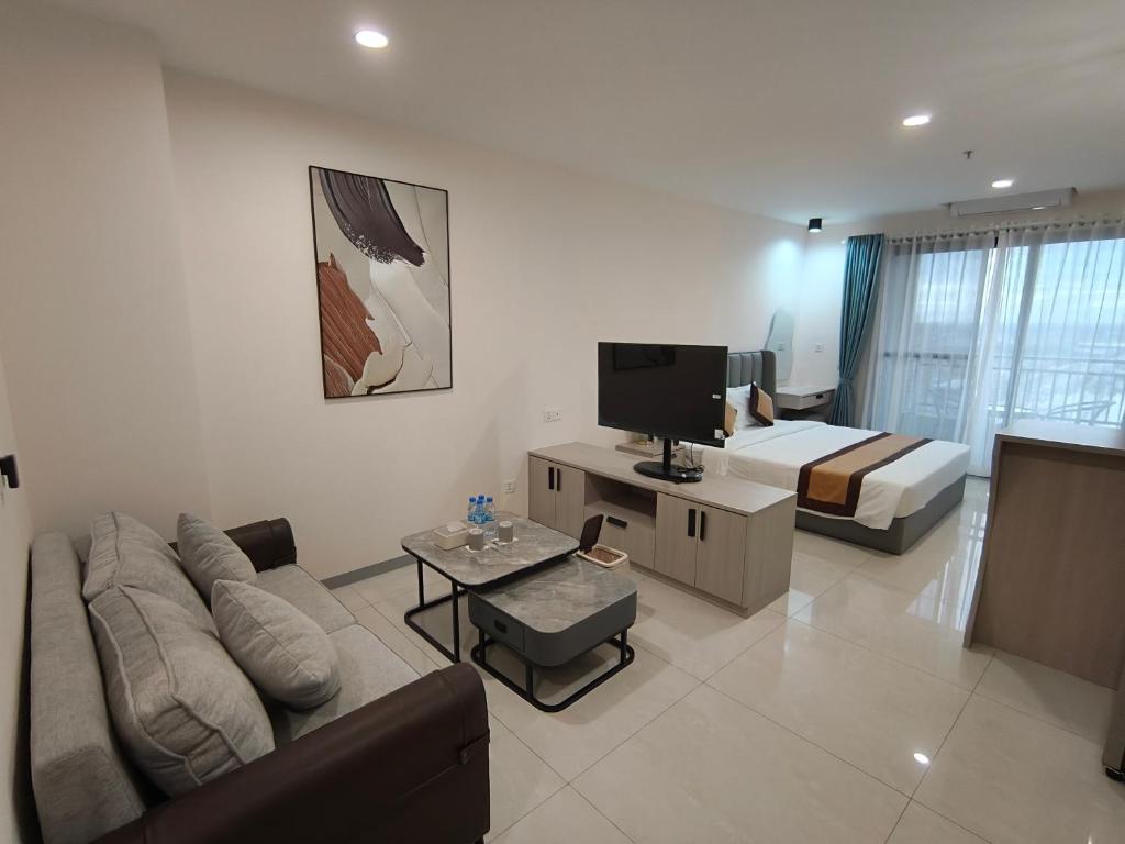 een woonkamer met een bank en een bed bij Jian DaoBao in Phnom Penh