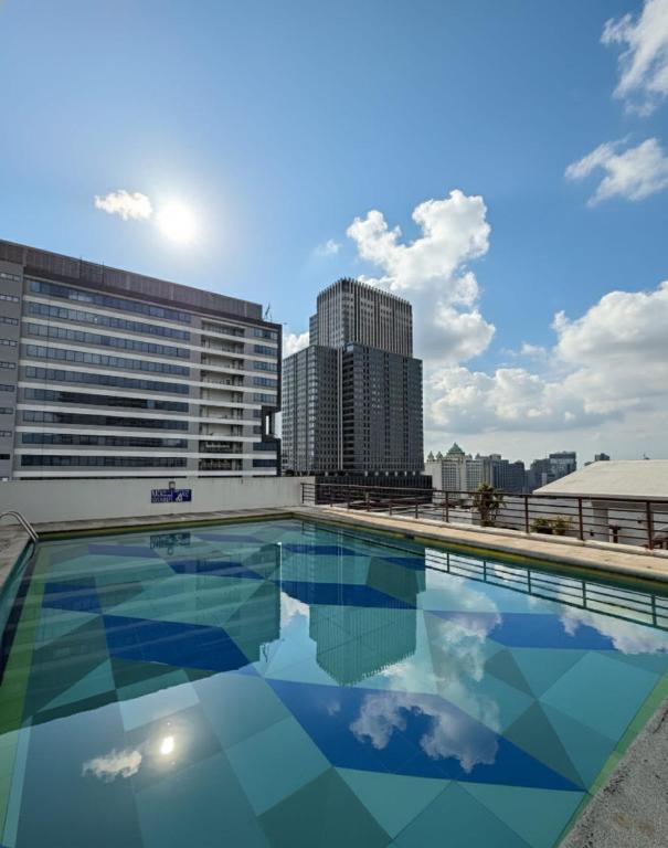 a swimming pool on the roof of a building at Penthouse A Near IT Park in Cebu City