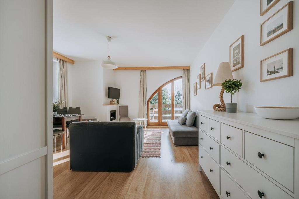 a living room with a couch and a table at WHY NOT Apartamenty widokowe PANORAMA in Kościelisko