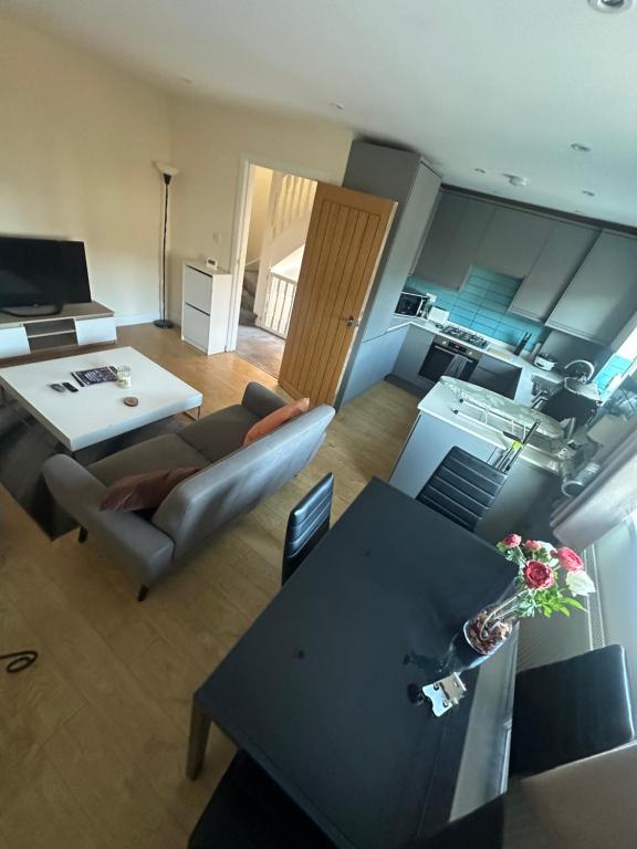 a living room with a couch and a table at Double room -Quite -Close to Elizabeth line in London