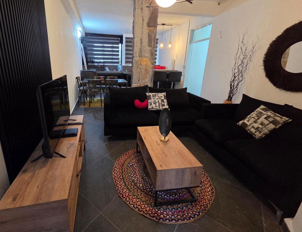 The Reset في غراند بايَ: غرفة معيشة مع أريكة سوداء وطاولة