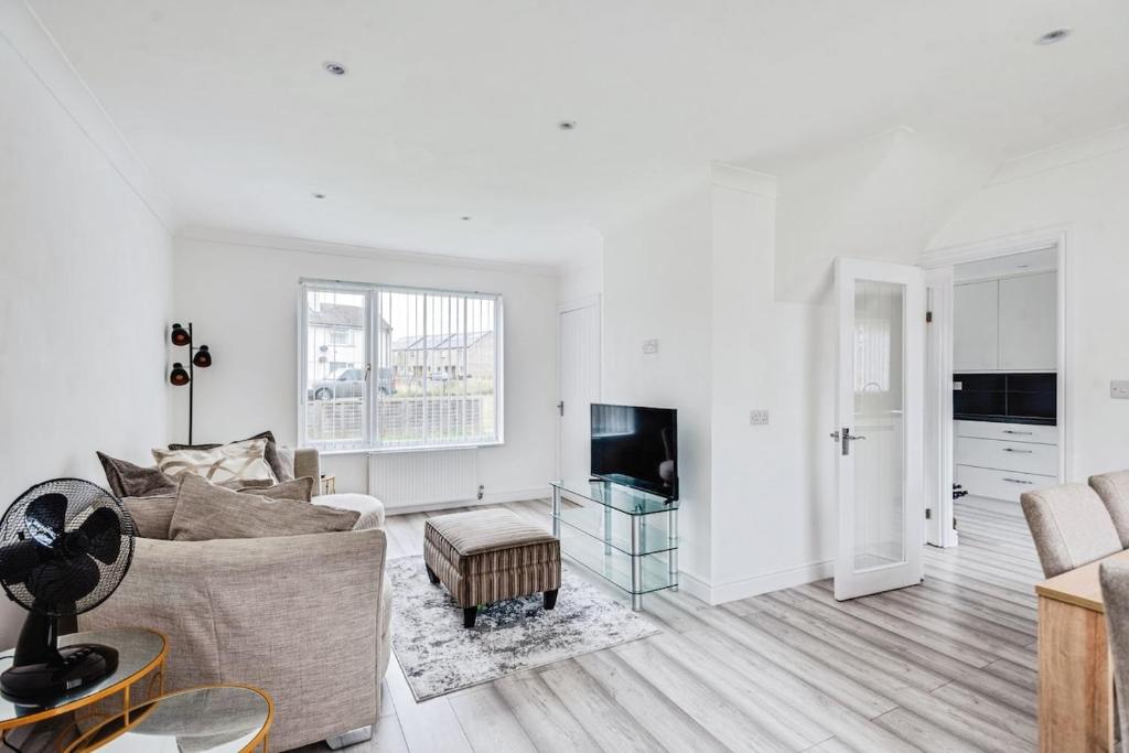 een woonkamer met een bank en een tv bij The Escape in Swindon