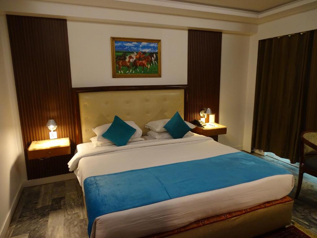 Postel nebo postele na pokoji v ubytování Hotel Galaxy