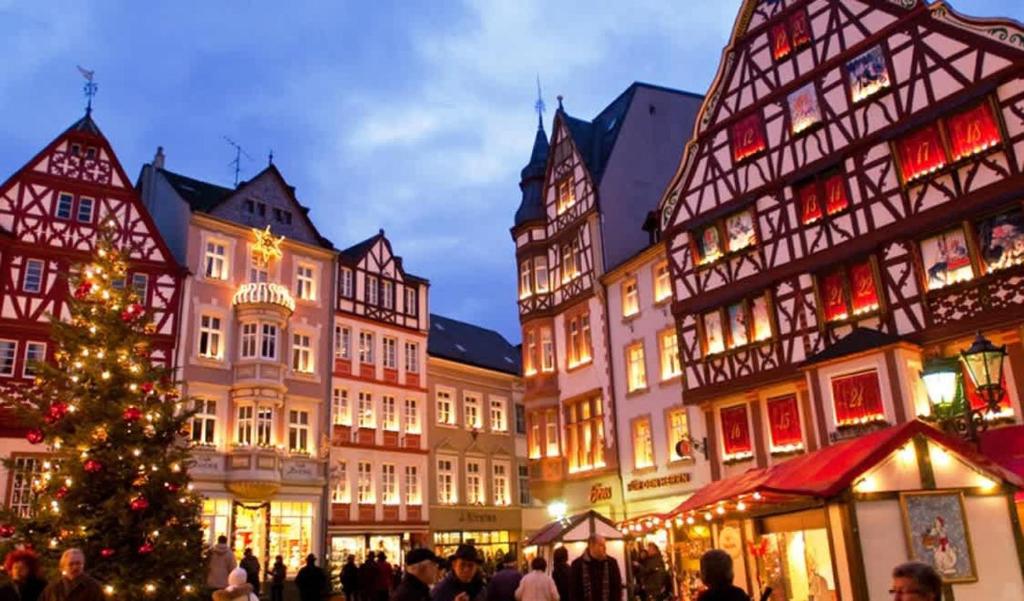 a christmas market in a town with a christmas tree at Central Bern Flat - Balcony & Bundeshaus View in Bern