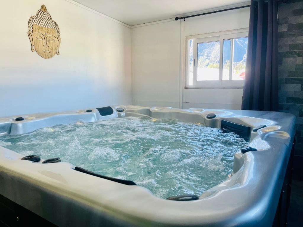 a jacuzzi tub with water in a room at L'Etape du Bonheur in Cilaos