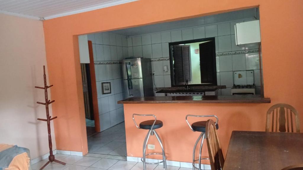 a bathroom with a counter with two chairs and a mirror at Camping-Casa Saco do Ceu in Saco do Ceu