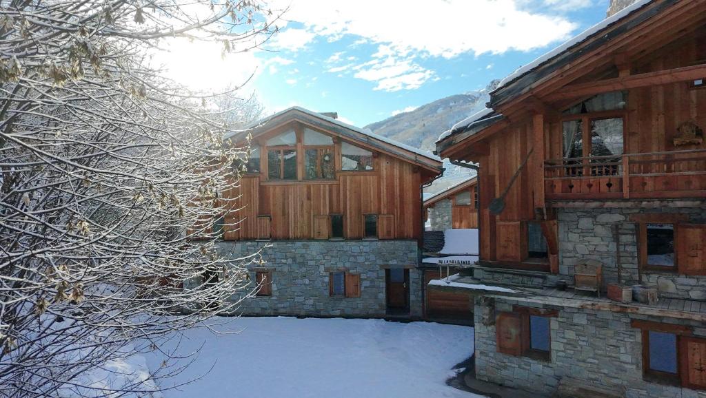 a building with snow in front of it at Le Cochet by Lodji in Saint-Martin-de-Belleville