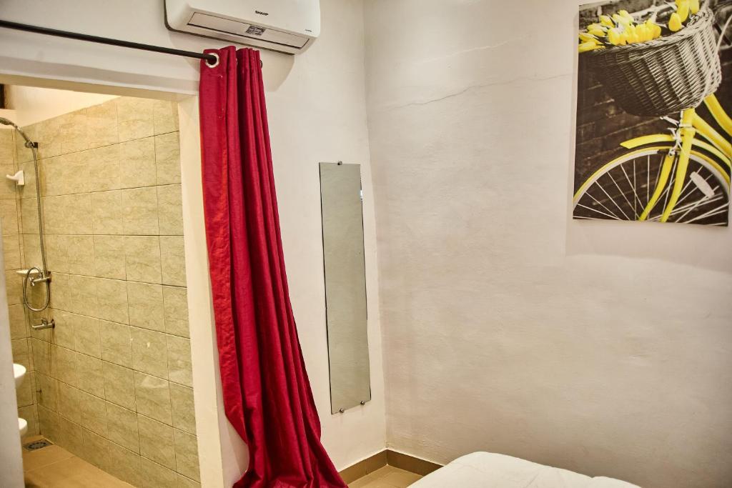 ParakouRésidences Fifamè的浴室里设有红色窗帘的淋浴