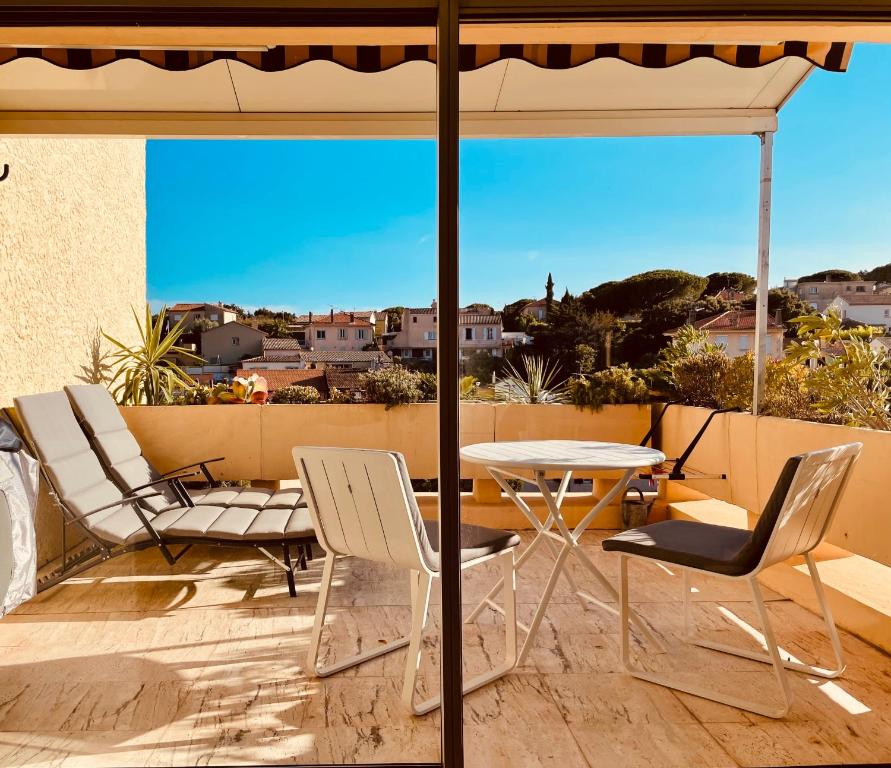 a patio with a table and chairs and an umbrella at Studio avec terrasse sud proche bord de mer in Sainte-Maxime