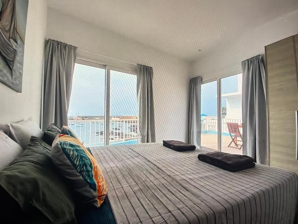 a bedroom with a bed with a view of the ocean at The Blue Haven in Sal Rei