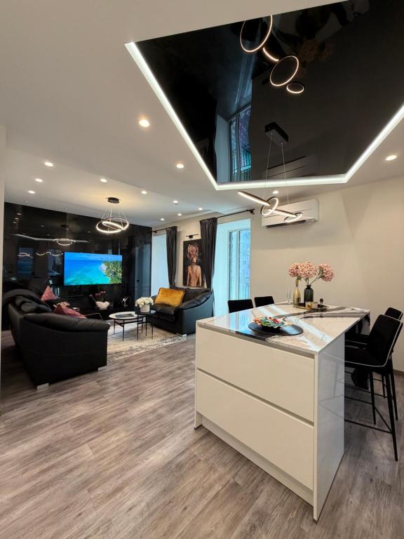 a living room with a kitchen and a living room with furniture at Koralas in Klaipėda