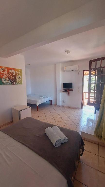 Una cama o camas en una habitación de Pousada Canoa Beach