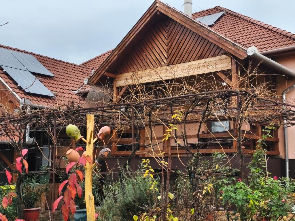 a house with a bird nest on the front of it at Vár-Liget Vendégház in Kisnána