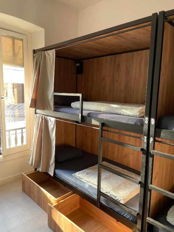 two bunk beds in a room with a window at Downtown River Hostel in San Sebastián