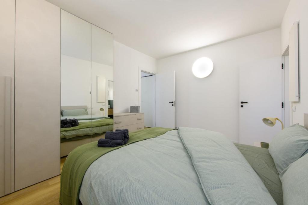 a bedroom with a large bed and a mirror at Appartamento Santa Maria Nuova in Reggio Emilia