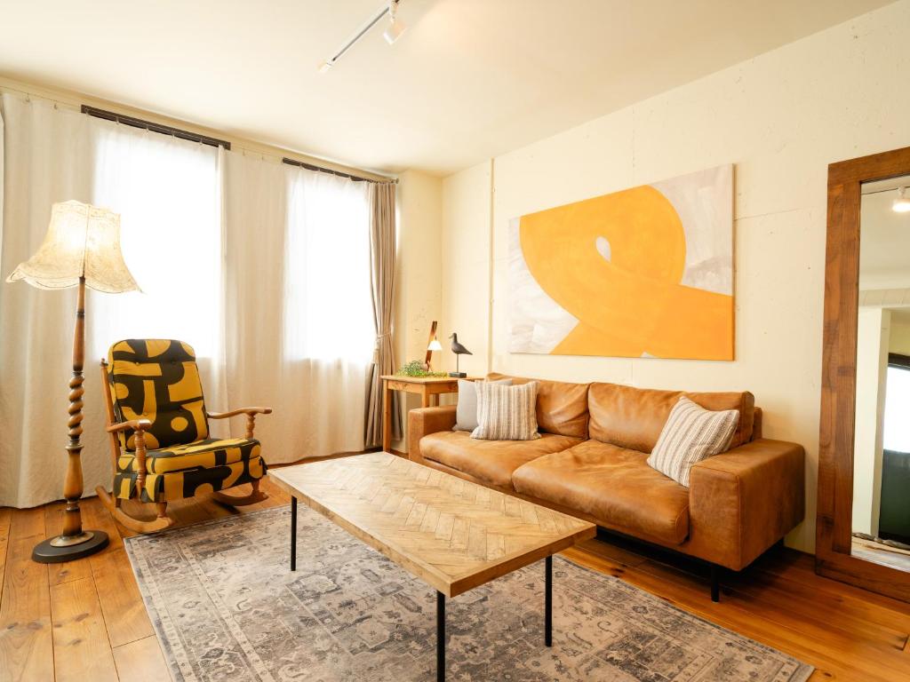 a living room with a couch and a coffee table at お宿Ｇａｎ福田町-Luxury Stay-駐車場無料 in Takamatsu