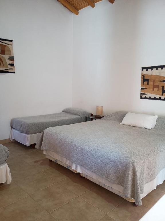 a bedroom with two beds in a room at El Refugio de Coquena in Purmamarca