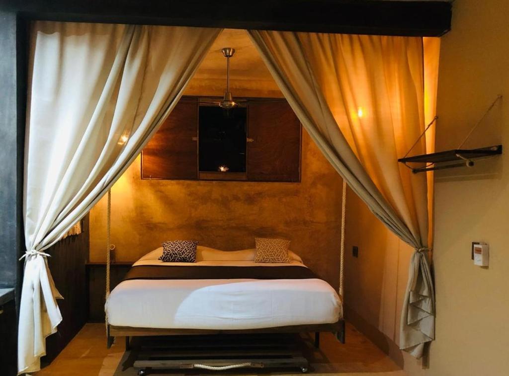 a bedroom with a bed with a canopy at Casa MANDALA in Santa María Colotepec