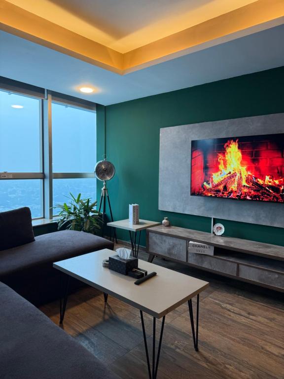 a living room with a couch and a fireplace at 2Bed Apartment in Centaurus with City and Margalla views in Islamabad