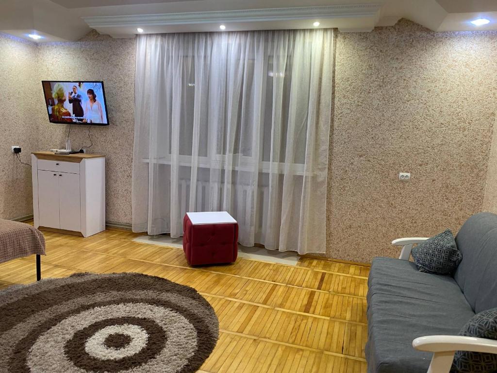 a living room with a couch and a table at Апарт Отель Элин in Svalyava