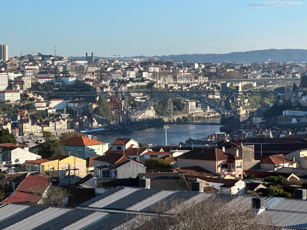 a view of a city with a river and a bridge at New Douro Tower 305 with shared pool and parking in Vila Nova de Gaia