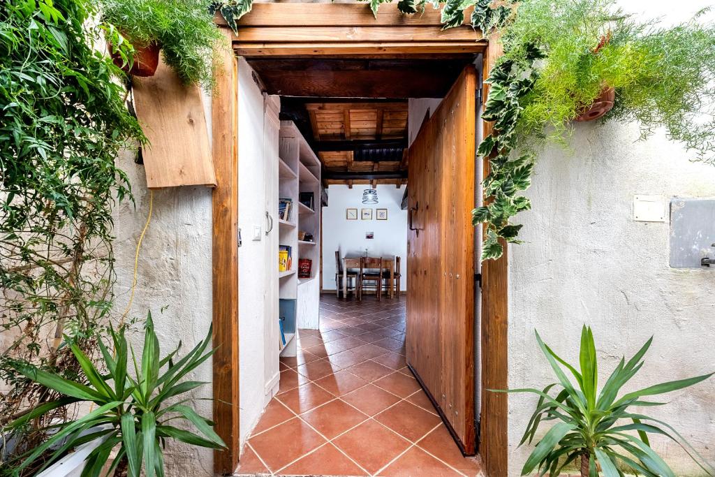 an entrance to a house with a wooden door at Casa Puggimiano in Poggio Moiano
