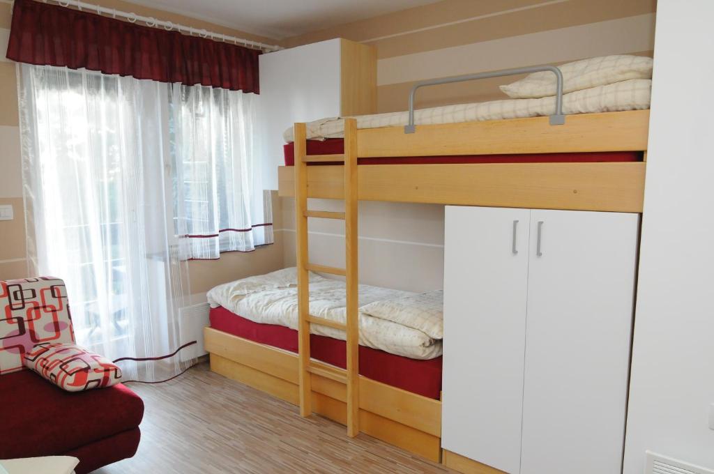 a bedroom with two bunk beds in a room at Zeleni Apartment Rogla in Zreče