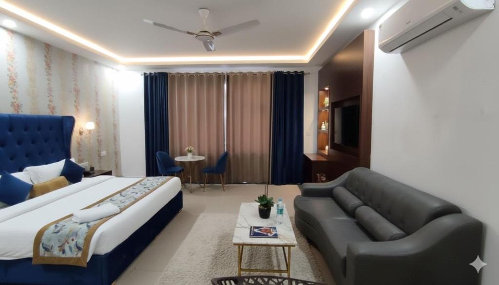 a hotel room with a bed and a couch at Hotel Claytone Near Delhi Airport in New Delhi