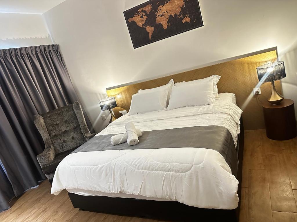 a bedroom with a large bed and a chair at Nasai Retreat Studio in H Elite Design Building in Kota Bharu